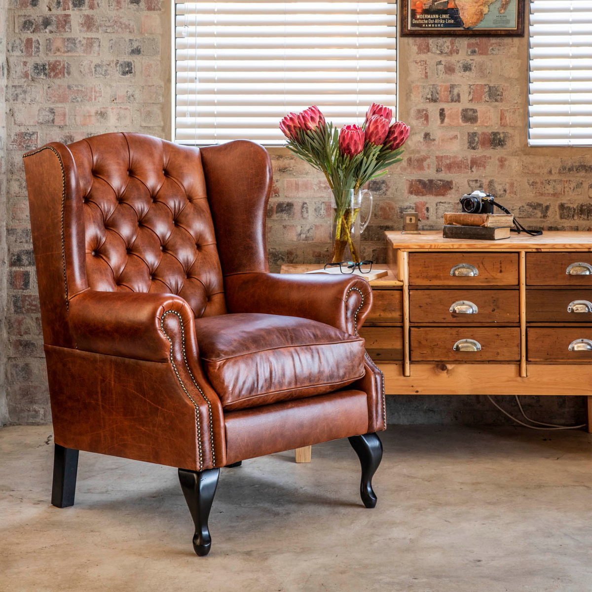 Tufted Chesterfield Wingback Armchair – A timeless favorite and best-seller, this tufted Chesterfield Wingback Armchair is a masterpiece of traditional design. Upholstered in distressed leather and adorned with deep button tufting, these chairs exude distinctive elegance. Indulge in the luxury of customization with these chairs, custom-made in premium leathers for a truly unique and stylish addition to your space.