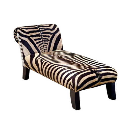 Luxurious Burchell Zebra Chaise Lounge – Elevate your space with this opulent chaise lounge, upholstered in Burchell Zebra and crafted with African Mahogany Timber by skilled artisans. Immerse your dwelling in an authentic African touch with this exquisite piece.  Customize sizes and designs to your preference, choosing from a variety of hair-on hides, skins, and fabrics. Worldwide shipping available for the distinctive Burchell Zebra hides.