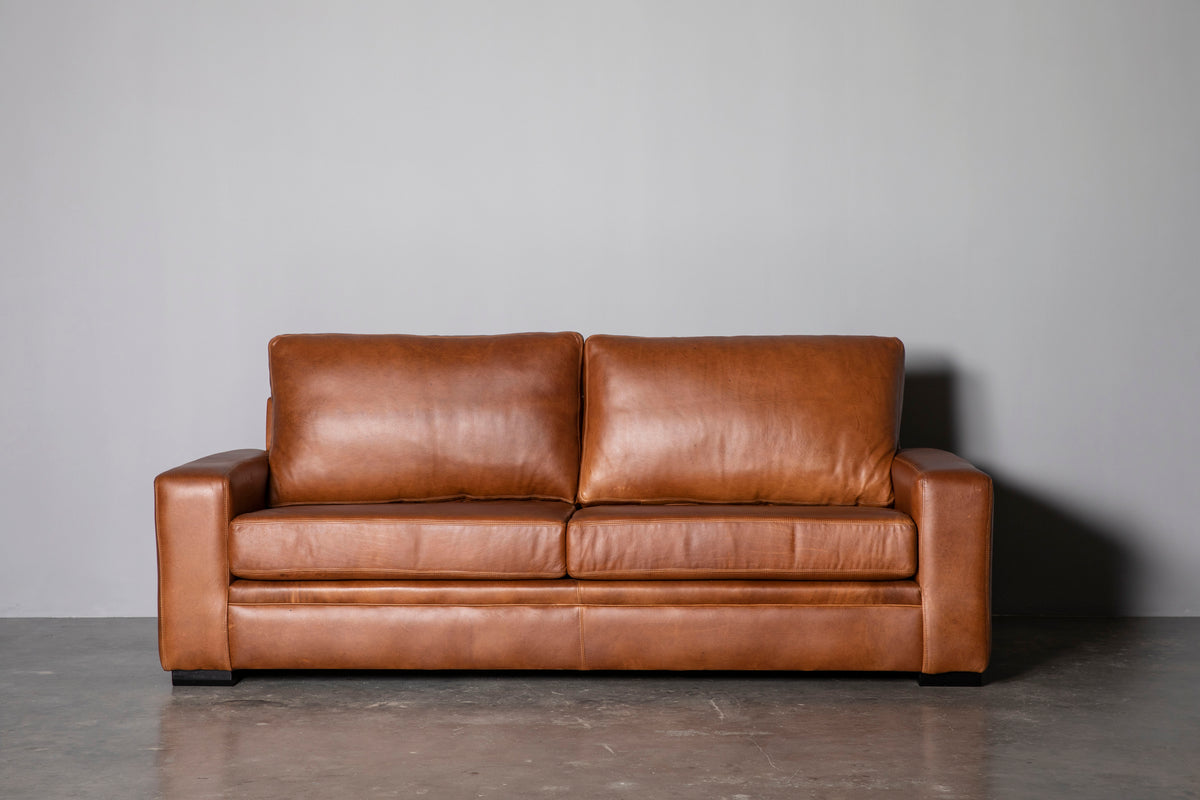 Manhattan Collection – Elevate your space with our versatile Manhattan design, available in Sofas, Daybeds, and Corner Units. Offering a relaxed feel with support in the seat and back, it's the perfect choice for various activities such as watching, listening, reading, or entertaining. Customize your experience with any size you desire and a wide range of premium leathers and fabrics, capturing your own personal style. Each piece is custom manufactured for a truly unique addition to your living space.
