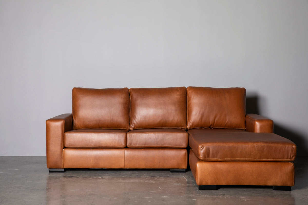 Manhattan Collection – Elevate your space with our versatile Manhattan design, available in Sofas, Daybeds, and Corner Units. Offering a relaxed feel with support in the seat and back, it's the perfect choice for various activities such as watching, listening, reading, or entertaining. Customize your experience with any size you desire and a wide range of premium leathers and fabrics, capturing your own personal style. Each piece is custom manufactured for a truly unique addition to your living space.