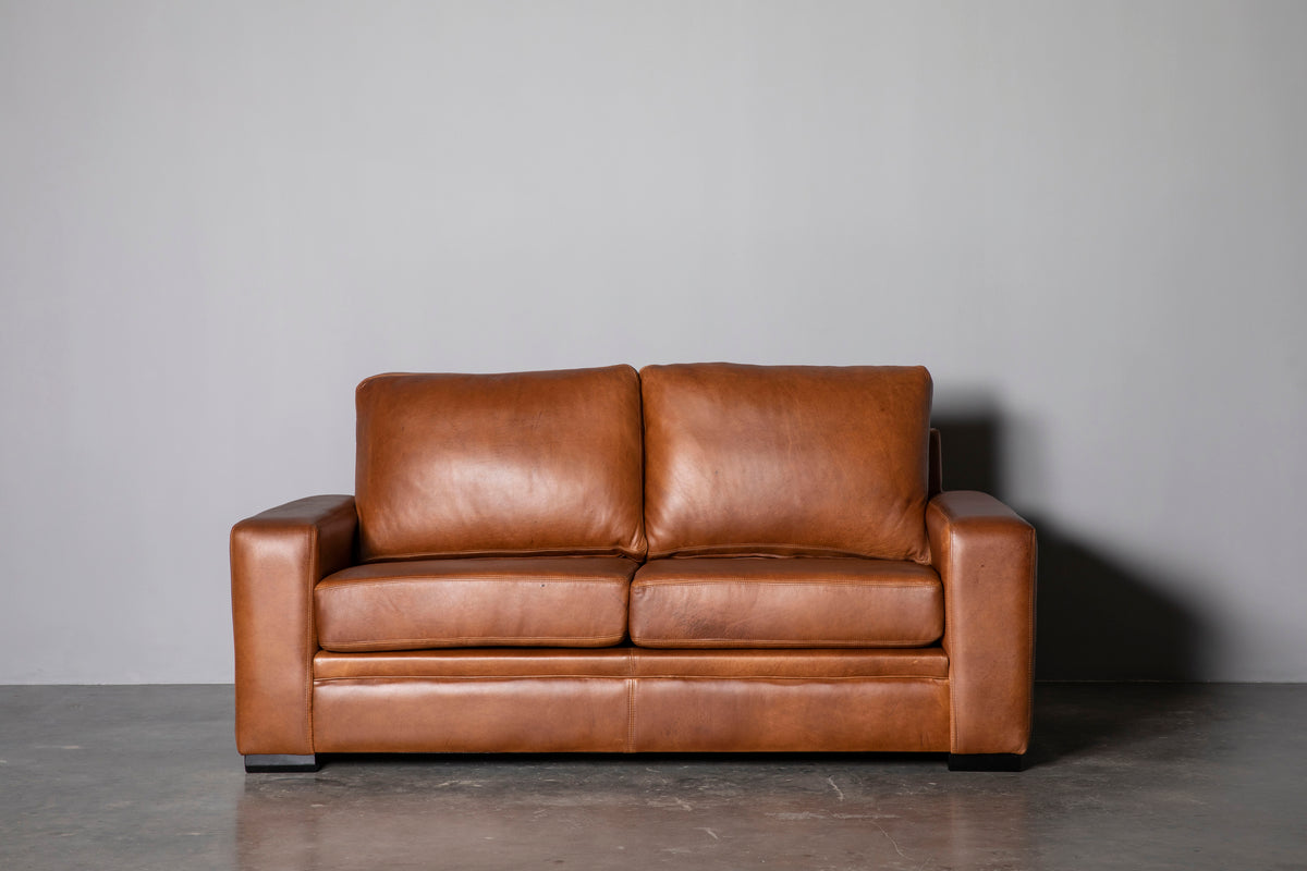 Manhattan Collection – Elevate your space with our versatile Manhattan design, available in Sofas, Daybeds, and Corner Units. Offering a relaxed feel with support in the seat and back, it's the perfect choice for various activities such as watching, listening, reading, or entertaining. Customize your experience with any size you desire and a wide range of premium leathers and fabrics, capturing your own personal style. Each piece is custom manufactured for a truly unique addition to your living space.
