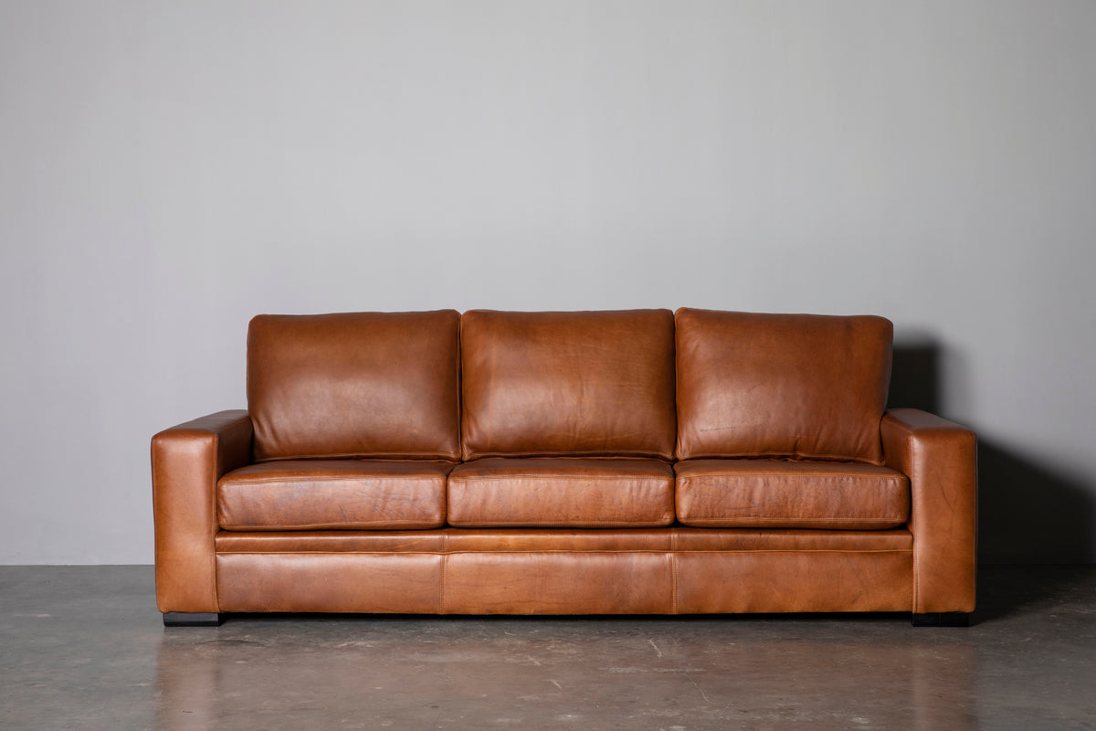 Manhattan Collection – Elevate your space with our versatile Manhattan design, available in Sofas, Daybeds, and Corner Units. Offering a relaxed feel with support in the seat and back, it's the perfect choice for various activities such as watching, listening, reading, or entertaining. Customize your experience with any size you desire and a wide range of premium leathers and fabrics, capturing your own personal style. Each piece is custom manufactured for a truly unique addition to your living space.