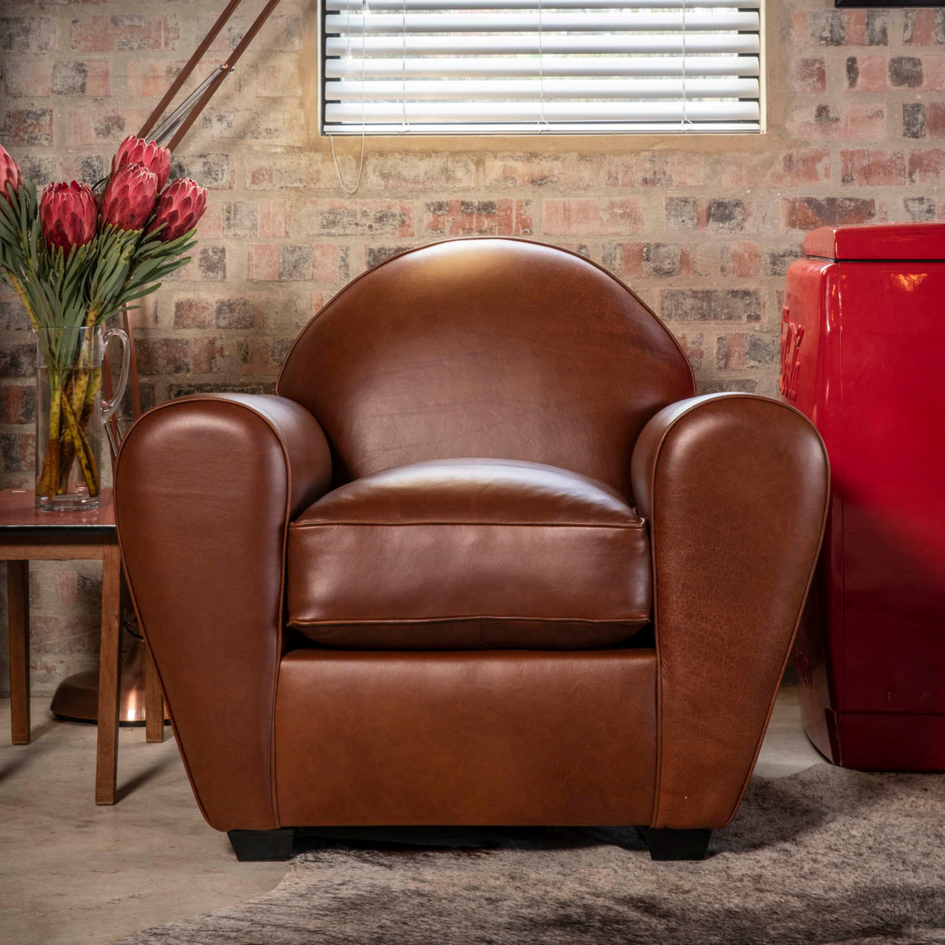 Cuba Armchair – Inspired by the cigar lounges of Havana, the Cuba Armchair boasts a low-profile sprung back and a soft-filled cushion, providing the perfect setting for kicking back and chilling.  Personalize your experience by choosing your favorite color from our range of premium quality leathers. Immerse yourself in the comfort and style inspired by the vibrant atmosphere of Cuba.