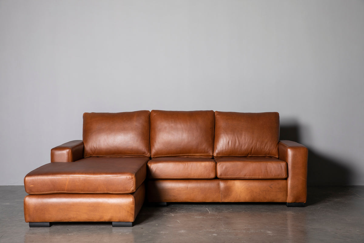 Manhattan Collection – Elevate your space with our versatile Manhattan design, available in Sofas, Daybeds, and Corner Units. Offering a relaxed feel with support in the seat and back, it's the perfect choice for various activities such as watching, listening, reading, or entertaining.  Customize your experience with any size you desire and a wide range of premium leathers and fabrics, capturing your own personal style. Each piece is custom manufactured for a truly unique addition to your living space.